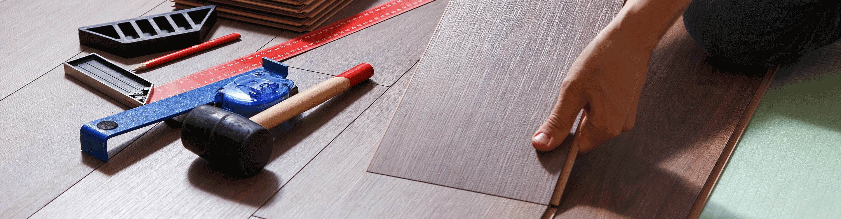 pile of wood look flooring and flooring installation tools